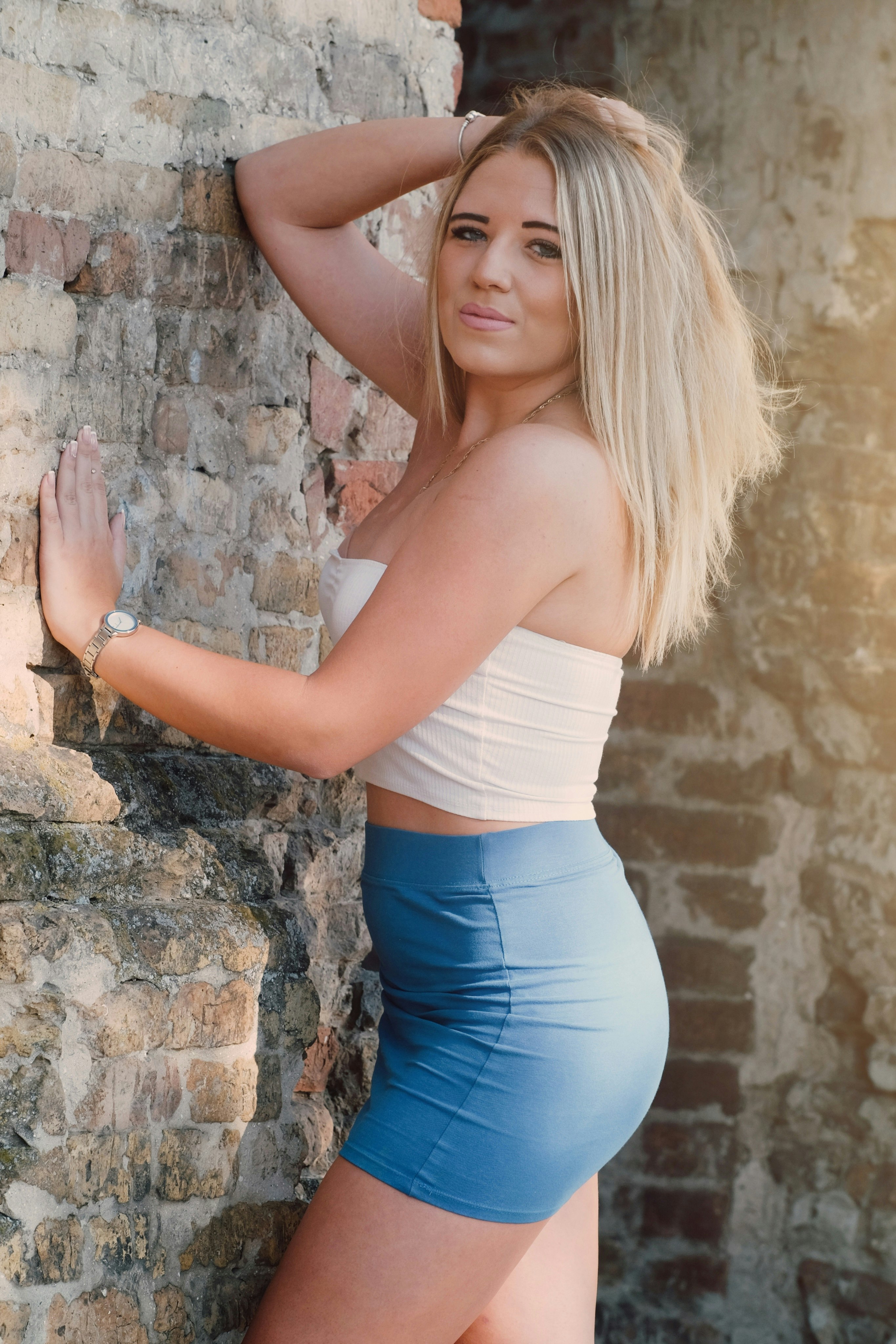 standing woman wearing white strapless crop-top during daytime